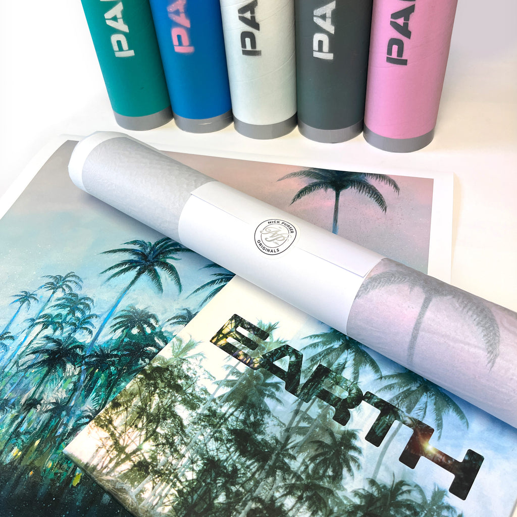 Palms print partly wrapped in tissue beside decorated postal tubes and the EARTH album cover featuring the related palm-tree photograph.